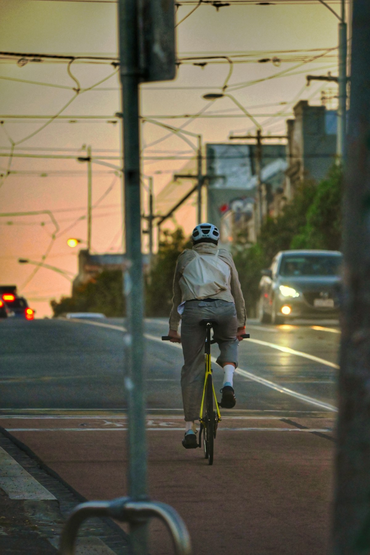 Cyclist riding through Northcote, Melbourne at sunset